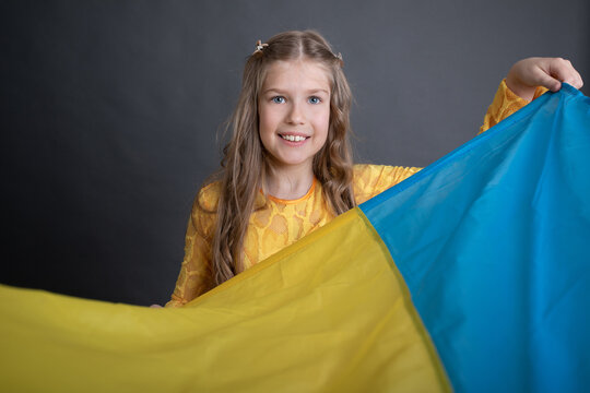 Littl girl holding Ukrainan flag