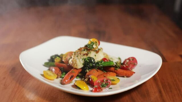 Smoking Delicious Halibut In A Plate Served With Vegetables. close up