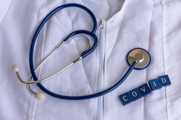 doctors coat with stethoscope and the word covid