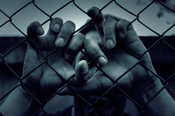 Hands on a fence