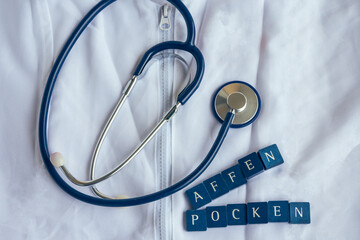 doctors coat with stethoscope and the german word monkey pox