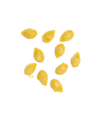 Pumpkin seeds over on white background. Selective focus.