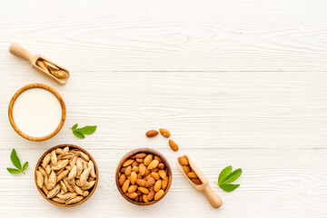 Fototapeta na wymiar Vegan organic drink - almond milk with almond nuts, top view
