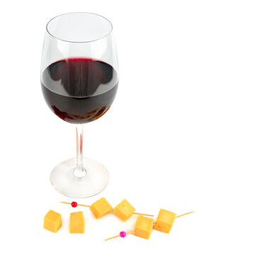Glass of red wine and pieces of cheese isolated on white . Place for your text.