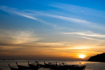 Dawn sky between blue and gold color with silhouette fisherman's boat horizontal view in Koh Lipe, Thailand