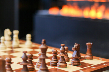 Modern glass corner fireplace wall in the interior. Game. Success. Sports. Chess financial business strategy concept. Great Chess board.
