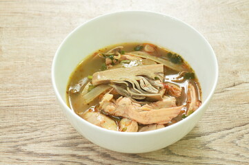 spicy boiled chicken meat with ripe banana blossom soup on bowl
