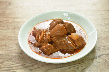 boiled spicy pork belly in curry soup or Hang leh Thai northern style food on plate 