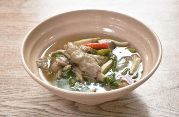 spicy boiled mixed mushroom and basil leaf soup on bowl 