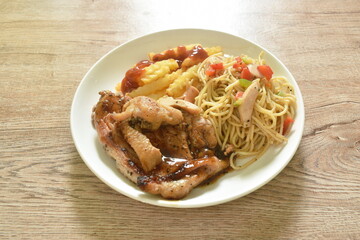 grilled chicken black pepper steak dressing spicy sauce with French fries and fried spaghetti sausage on plate