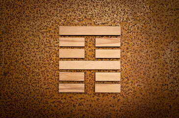 wooden Gene Key 52 i ging hexagram on rusty metal background human design
