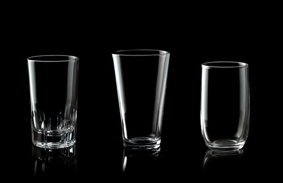 Set of empty glass of water isolated on black background