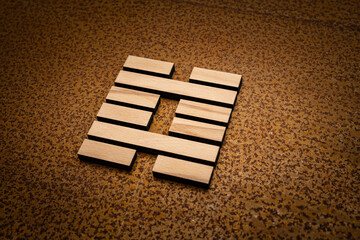 wooden Gene Key 29 i ging hexagram on rusty metal background human design