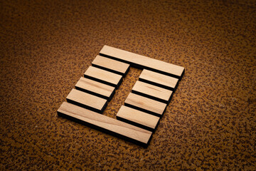 wooden Gene Key 27 i ging hexagram on rusty metal background human design