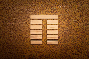 wooden Gene Key 23 i ging hexagram on rusty metal background human design