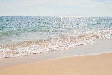 Fototapeta na wymiar Sand and beach with frothy wave 