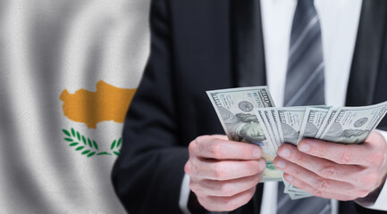 Hands holding dollar money on flag of Cyprus