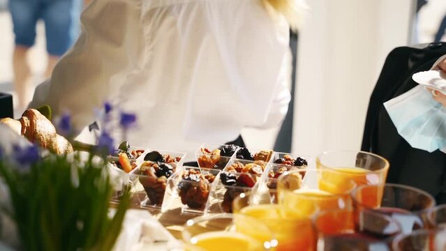 Catering service on banquet table with canape snacks in restaurant or hotel. Decorated food set with drinks, nuts and dried fruits on birthday, wedding celebration or business conference event venue.