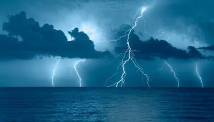 Beautiful landscape with lightning over the calm sea at sunset  - obrazy, fototapety, plakaty