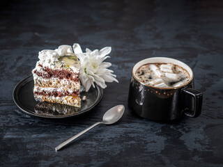 Coffee with marshlelows and a cake with a chrysanthemum flower for a pleasant snack