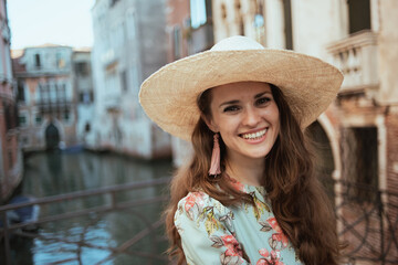 Portrait of happy young woman in floral dress having excursion
