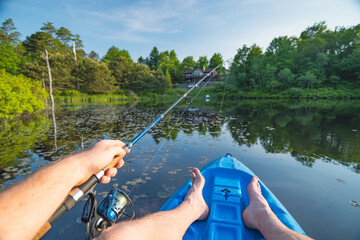 fishing on the river, kayak, holding fishing rod, freshwater fishing.