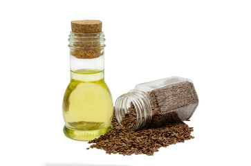Glass bottle with linseed oil and flax seeds.
