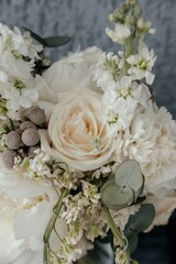 a bouquet of white roses and peonies close up, vertical image