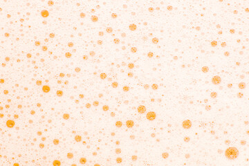 Yellow bubbles and foam on the water, background.