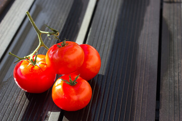 red tomatoes with drops on a light background, copy space for text	
