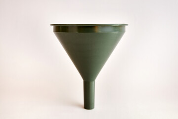 Green plastic watering can on a white background.