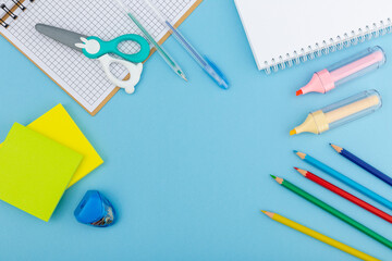 School supplies on a blue background, top view.