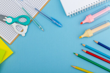 School supplies on a blue background, top view.