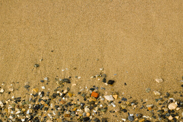 Wet, clean, sandy and stony beach background,top view
