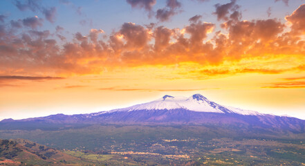 Fototapeta premium picturesque sunset or sunrise landscape with amazing view to majectic high mountain with snow on top and scenic cloudy sunset on background