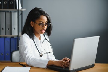 African female doctor make online telemedicine video call consult patient. Afro american black woman therapist talking to camera in remote videoconference chat. Webcam view, face headshot.