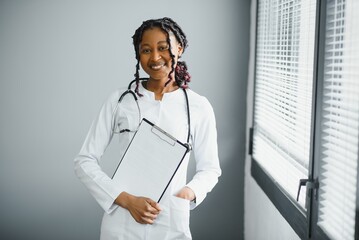 happy young african female nurse working in office
