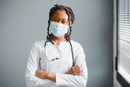 African female doctor in protective facial mask