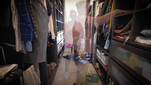 A woman is spring cleaning in a spacious luxury walk in wardrobe. Timelapse.