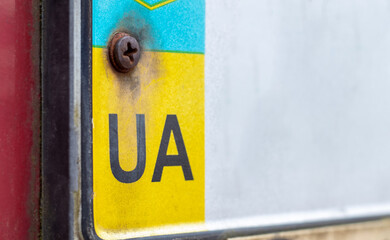 Part of the Ukrainian license plate on the bumper close-up. The symbol of nationality on the...