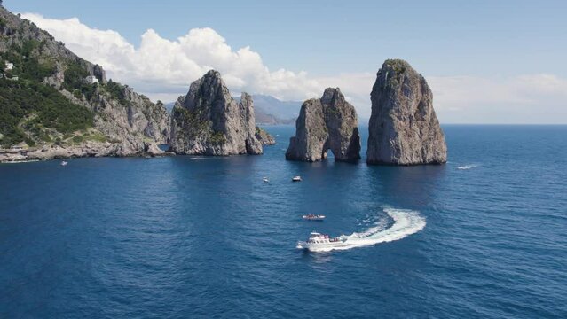 Boats by Faraglioni Famous Rock Landmarks off Capri Island, Italy - Aerial