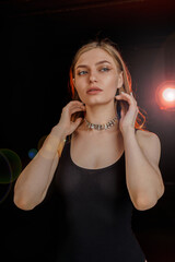 Young woman  in the neon light of the club.  Portrait of a beautiful girl close-up. Lady in multicolor glow.