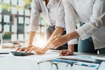 financial, Planning, Marketing and Accounting, Asian woman Economist pointing to investment documents with partners on profit taking to compete with other companies