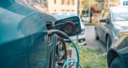 Power supply for electric car charging. Electric car charging station on urban europe street with...