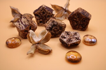 Sandalwood pot pourri with glass marbles on a terracotta background