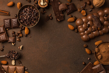 Chocolate background with chocolate pieces, chocolate chips, nuts, cocoa