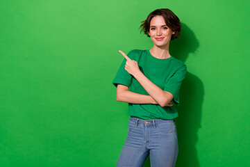 Photo of confident pretty lady wear spring outfit pointing empty space smiling isolated green color...