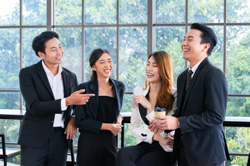 Group of Asian businessmen taking a coffee break with colleagues at the office have fun talking