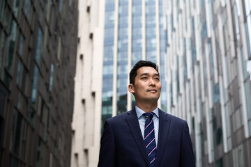 Asian businessman walking through city on his commute