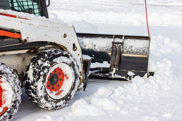 Snow removal equipment. Shoe snow on the sidewalk.